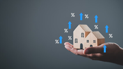 house or building or land value property tax, local development tax concept. Word tax, home model on hand, depicts ad valorem tax on value of a property.