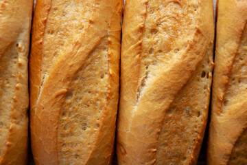 Homemade Mini baguette on a white wooden background, top view. Flat lay, overhead, from above.