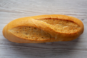 Homemade Mini baguette on a white wooden background, top view. Flat lay, overhead, from above.