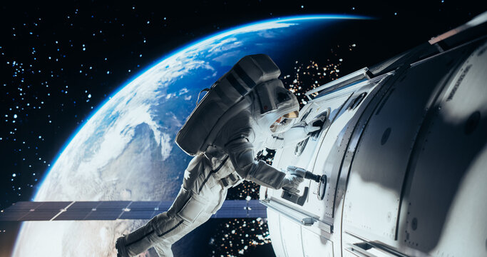 Space Technician Mending a Panel on an International Space Station with an Automatic Screw Gun. Fearless Astronaut Working in Outer Space with Gorgeous Blue Planet in the Background - Powered by Adobe