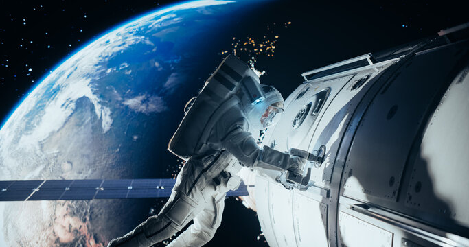 Space Technician Mending a Panel on an International Space Station with an Automatic Screw Gun. Fearless Astronaut Working in Outer Space with Beautiful Planet Earth in the Background