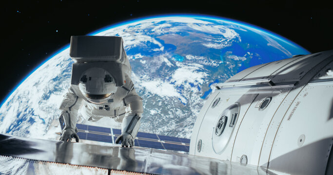 Space Engineer Servicing a Panel on a Communication Satellite, Checking For Damages Or Malfunctioning. Brave Astronaut Working in Outer Space with Beautiful Blue Planet Earth in the Background
