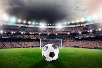 Classic soccer ball on green field in stadium