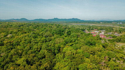 Obraz premium Aerial drone view of lush green rural scenery at Pantai Jambu Bongkok, Marang, Terengganu, Malaysia