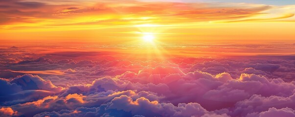 Fototapeta premium A breathtaking sunrise above the clouds, with brilliant colors painting the sky in hues of orange, pink, and purple.