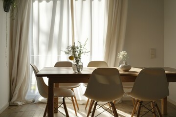 Dining area with wooden table and modern white chairs.