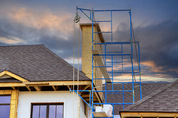 House under construction joist framework with featuring plywood is installed, gutter holders, soffit fascia trim