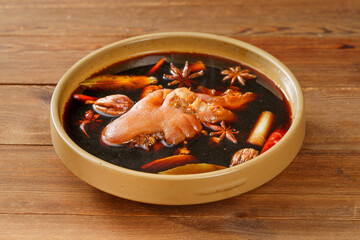 Wooden background board casserole braised pig's trotter