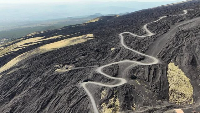 Aerial shot of a winding road on Mount Etna, volcano on Sicily, Italy