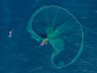 Aerial view of traditional wooden boat and fishermen are fishing anchovies in Yen Island, Phu Yen...