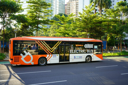 Transjakarta electric buses operating in the sudirman and thamrin areas are stopping and dropping off passengers. These buses are environmentally friendly.  Jakarta, Indonesia.