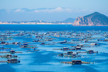 Aerial view of the lobster feeding farms, float fishing village in Vung Ro bay, Phu Yen, Vietnam....