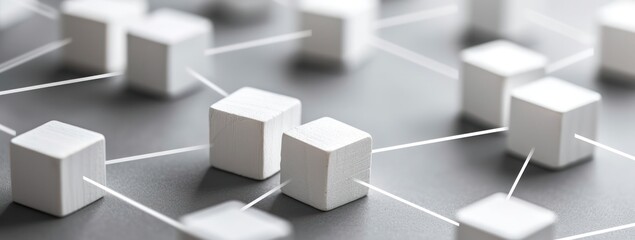 Fototapeta premium 3D rendering of a network of white cubes connected by strings on a gray surface.