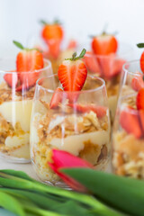 Homemade portioned dessert called Lazy Napoleon cake with puff pastry, custard and decorated with fresh strawberries