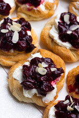 Homemade puff pastry cakes with cottage cheese and cherry jam