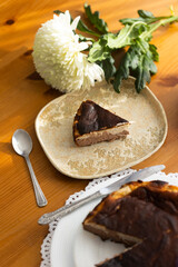 Homemade banana and chocolate Basque cheesecake with the cut piece on plate