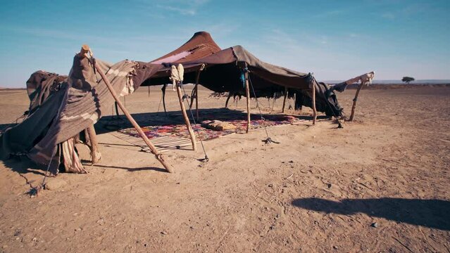 Berber Moroccan tent in the middle of the Sahara Desert. Rustic wool and dromedary fabrics are used to build a tent to provide shade