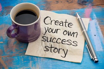 A rustic blue table with coffee mug, napkin Create your own success story pen