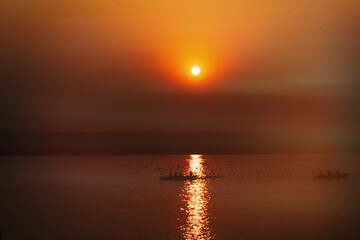 Boats during sunset. Dawn on sacred river Ganges in Varanasi, India