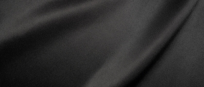 A close-up shot of black fabric with soft, wavy texture.