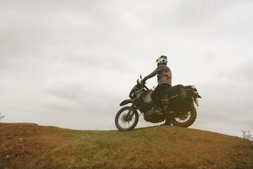 Obraz premium Motorcyclist traveling on adventure tourist enduro motorcycle outdoor in mountains