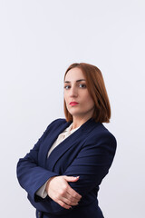 Portrait of a young professional, working or business woman with arms crossed looking at the camera on white background. Copy space. Concept of business and woman