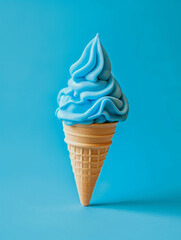 A Light Blue ice cream cone on a blank blue background, summery setting for a stock photo with copy space, clean colors and lines