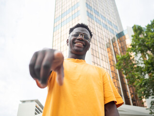 Portrait of a funny carefree funky African American young man in a city