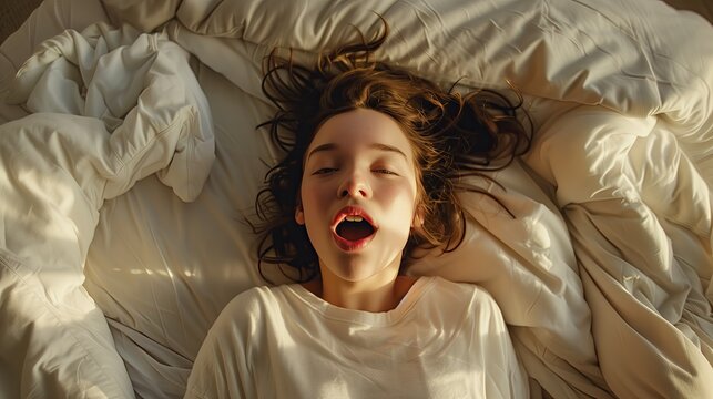 young woman in bed, close up, smiles, moans with pleasure, orgasm, sexual experience, masturbation, cunnilingus. Spa concept