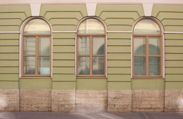 Three arched windows on the ground floor of the house