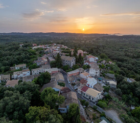 Aerial drone view of a traditional village in north corfu, summer view with sunset