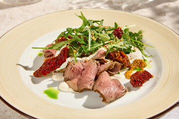 Succulent Roast Beef with Arugula, Sun-Dried Tomatoes, and Cheese Mousse in Natural Light on Beige Table