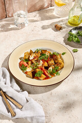 Crispy Eggplants with Tomatoes and Cheese in Sweet and Sour Sauce - Sunlit Still Life on Beige Table