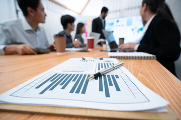 Focus financial dashboard paper showing graphs and chart with blurred background of diverse...