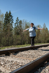 An elderly woman on the railway.