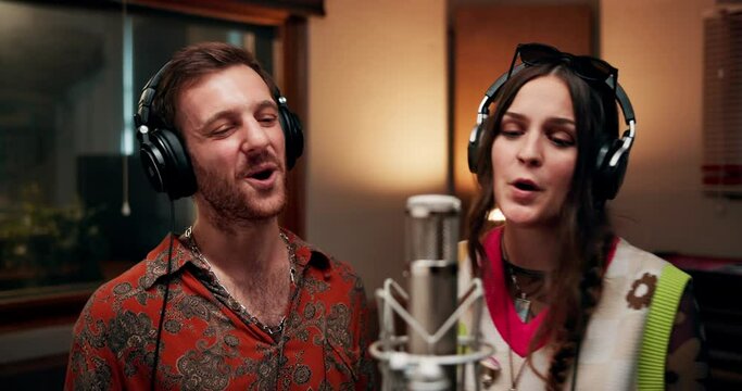 People, musician and singing in music studio for song recording with microphone for voice control. Group, duo and artist or friends with headphone as singer for collaboration and teamwork for album