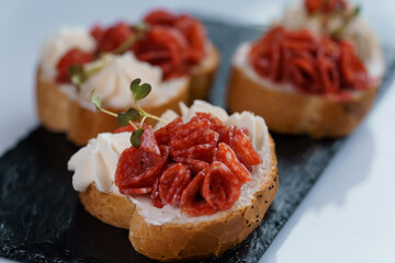 Canapes with sun-dried tomato and salami