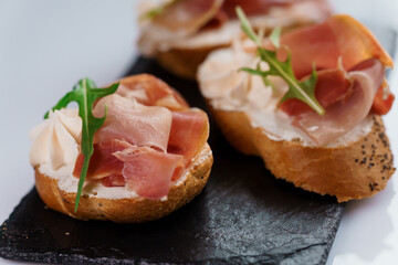 Canapes with sun-dried tomato and salami