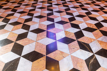 Geometric tile pattern on the floor of the Silk Exchange in Valencia. Optical illusion.