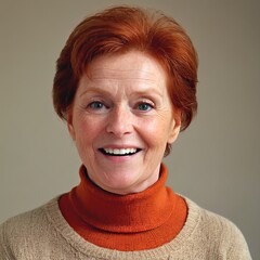 Old woman with red hair and blue eyes, smiling warmly at the camera. She has a natural look with visible wrinkles, wearing a beige sweater against a simple background. The overall mood is cheerful and