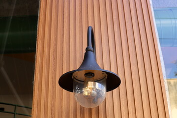 A lamp for illuminating the interior of the room hangs on the ceiling.