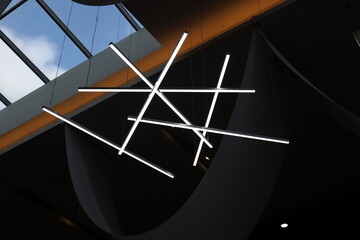 A lamp for illuminating the interior of the room hangs on the ceiling.