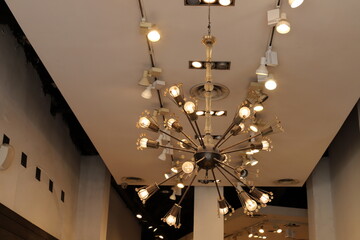 A lamp for illuminating the interior of the room hangs on the ceiling.