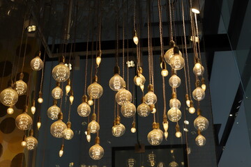 A lamp for illuminating the interior of the room hangs on the ceiling.