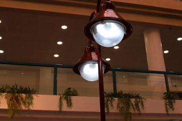 A lamp for illuminating the interior of the room hangs on the ceiling.