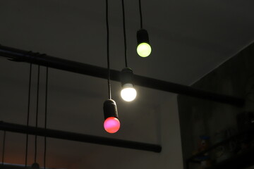 A lamp for illuminating the interior of the room hangs on the ceiling.