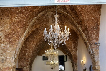 A lamp for illuminating the interior of the room hangs on the ceiling.