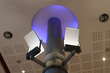 A lamp for illuminating the interior of the room hangs on the ceiling.