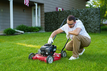 Young man change and check the oil in the motor lawn mower