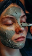 Fototapeta premium Teenage Girl Receiving Professional Facial Treatment with Clay Mask for Skincare in Dermatologist's Office